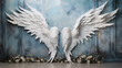 A pair of white, angel wings in a photography studio backdrop. Blue background. Potential graphic resource for use by photographers.