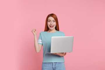 Canvas Print - Happy young woman with laptop on pink background