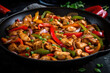 Delicious Szechuan chicken stir fry, packed with flavor from red and green bell peppers, onions, and garlic, served on a black cast iron skillet