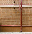 red brick wall of renovated old industrial building with newly installed drainpipe