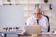 © Elnur - Old male employee working in the office