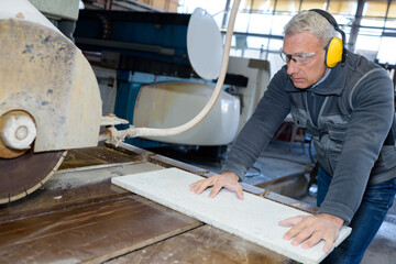 a worker and marble cutting worker