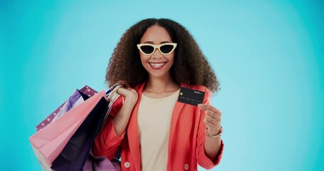 Wall Mural - Woman with credit card, portrait and shopping bag for fashion isolated on a blue background mockup space in studio. Happy, gift and face of African customer with plastic money in sunglasses for sales