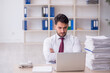 © Elnur - Young male employee and too much work in the office