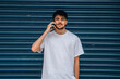 © carballo - young man or teenager with mobile phone in the street