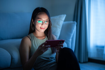 Canvas Print - Woman read on cellphone in the evening at home