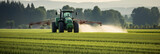 Fototapeta  - Tractor spraying pesticides fertilizer on soybean crops farm field in spring evening. Smart Farming Technology and Sustainable Advanced Agriculture Practices. Generative AI.
