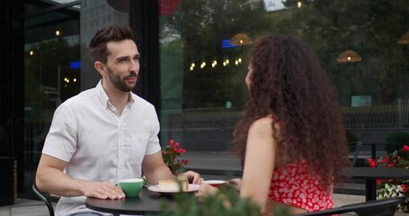 Sticker - Happy couple spending time together at outdoor cafe. Camera moving around them