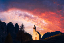 Incredible View On Small IIlluminated Chapel - Kapelle Ciapela On Gardena Pass, Italian Dolomites Mountains. Colorful Sunset In Dolomite Alps, Italy. Landscape Photography