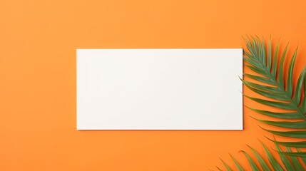 Poster - Blank mock up paper with dried palm leaf on orange background. Mockup image