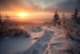 Fototapeta Most - Photo of a serene winter sunset over a snow-covered path