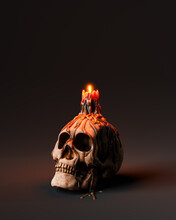 Human Skull With Burning Candle On Dark Background