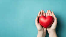 Red Heart In Hands On A Blue Background
