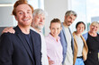 © Robert Kneschke - Portrait of smiling male and female business colleagues standing side to side at office