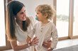 © ADDICTIVE STOCK CORE - Happy woman and toddler looking at each other and smiling