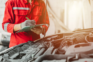 mechanic team check list engine repair maintenance oil liquid change at front hood of old car in auto service workshop