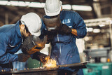 Fototapeta  - welding worker team working arc weld metal joint production in heavy industry danger and risk workplace with eyes safety equipment