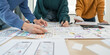 © Natee Meepian - UX developer and ui designer brainstorm about mobile app interface wireframe design with customer breif and color code at office