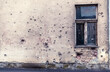 © Jelena Stanojkovic - Damaged building in Ukraine war. Historic war damage, bullet holes in residential building.