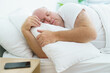 © DG PhotoStock - Caucasian white oversize body - fat man sleeping on the bed in bedroom close up. Health care and wellbeing concept.