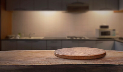 Empty wooden plate on wood table. Soft blurry background, of free space for your copy and branding. Use as products display montage. Vintage style concept.