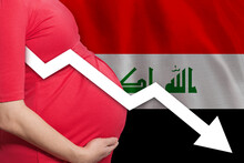 Belly Of Pregnant Woman On Flag Of Iraq Background. Falling Fertility Rate