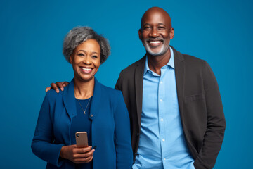 attractive mature black woman and black man with phone on studio color background. .