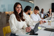© Johnér - Smiling woman sitting during business meeting and looking at camera