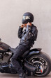 © Johnér - Mature biker in leather clothes putting on helmet