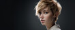 Close-up beauty portrait of a young blonde woman with short hair on a dark background
