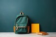 school, a school blackboard with a backpack and a yellow book on the desk