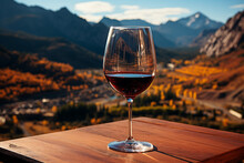 Wine In A Glass On A Wooden Table In The Mountains