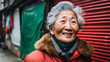 An elderly woman from South Korea enjoying a leisurely walk down a charming alley her eyes crinkling with joy as she shares a heartfelt smile. 