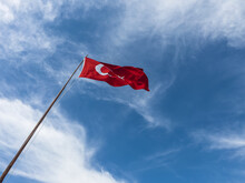 Turkish Flag Hoisted On Flagpole , Red Turkish Flag In Front Of Blue Sky