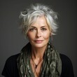 Portrait of a beautiful middle-aged woman with short grey hair with scarf