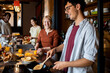 © Marko Geber - Diverse group of young roommates preparing and having breakfast together in their flatshare apartment