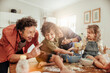 © Marko Geber - Young caucasian family being messy and having fun baking together in the kitchen