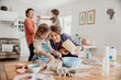 © Marko Geber - Young caucasian family being messy and having fun baking together in the kitchen