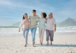 © Mumtaaz D/peopleimages.com - Love, smile and a family walking on the beach together for summer vacation or holiday in nature. Happy, freedom and travel with senior people, son or daughter outdoor for summer bonding by the ocean