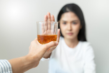 Wall Mural - woman refuse to drink alcohol say no to her friend.