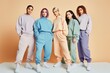 © A Denny Syahputra - group of women of different sizes and various races standing together in tracksuits on a pastel color background