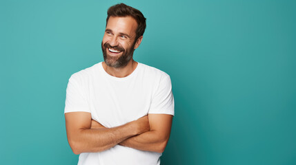 Wall Mural - Man standing in front of camera in white T-shirt , isolated on blue background