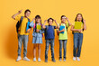© Prostock-studio - Happy kids pupils with backpacks and notebooks in their hands