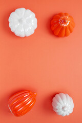 Wall Mural - Set of ceramic pumpkins on orange background. Fall decor, interior decoration. Flat lay, top view, copy space