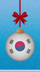 Wall Mural - Snow falling on christmas ball with flag of South Korea