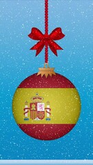 Wall Mural - Snow falling on christmas ball with flag of Spain