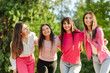 © Maria Vitkovska - Group of smiling confident women with pink ribbon on t shirts looking at camera