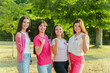 © Maria Vitkovska - Team of happy smiling women with pink ribbon on t shirts showing biceps
