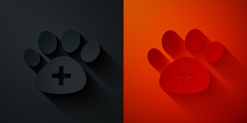 Poster - Paper cut Veterinary clinic symbol icon isolated on black and red background. Cross hospital sign. A stylized paw print dog or cat. Pet First Aid sign. Paper art style. Vector