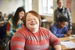 © Jasmina - Portrait of a young smiling man with Down syndrome in the classroom with his classmates. Social integration concept.